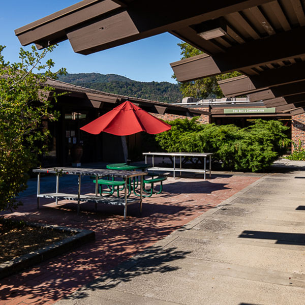 Building walkway with tables and umbrella