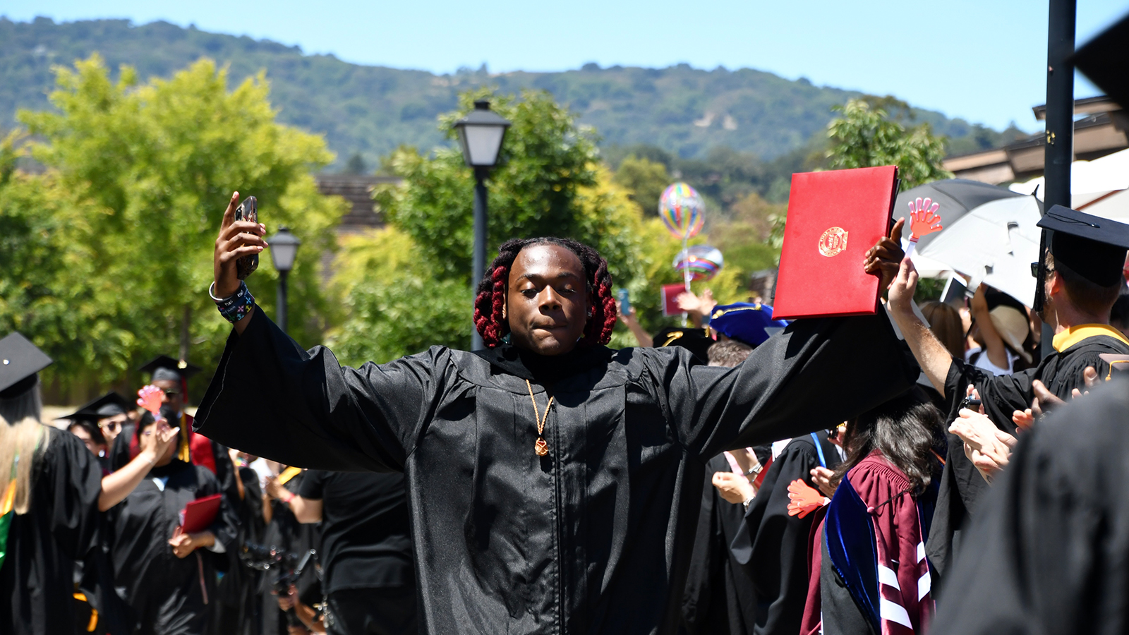 Foothill College male student celebrating graduation day