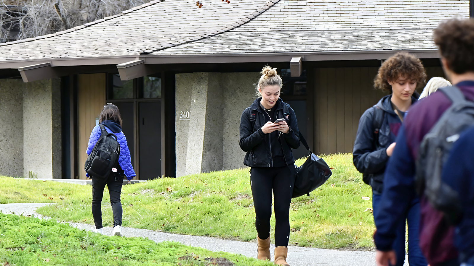 College students walking and using their phones