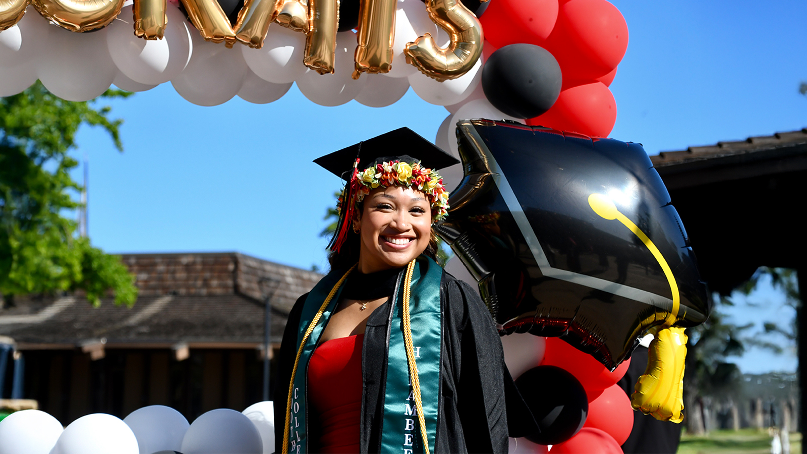 Female student at 2025 commencement celebration with balloons