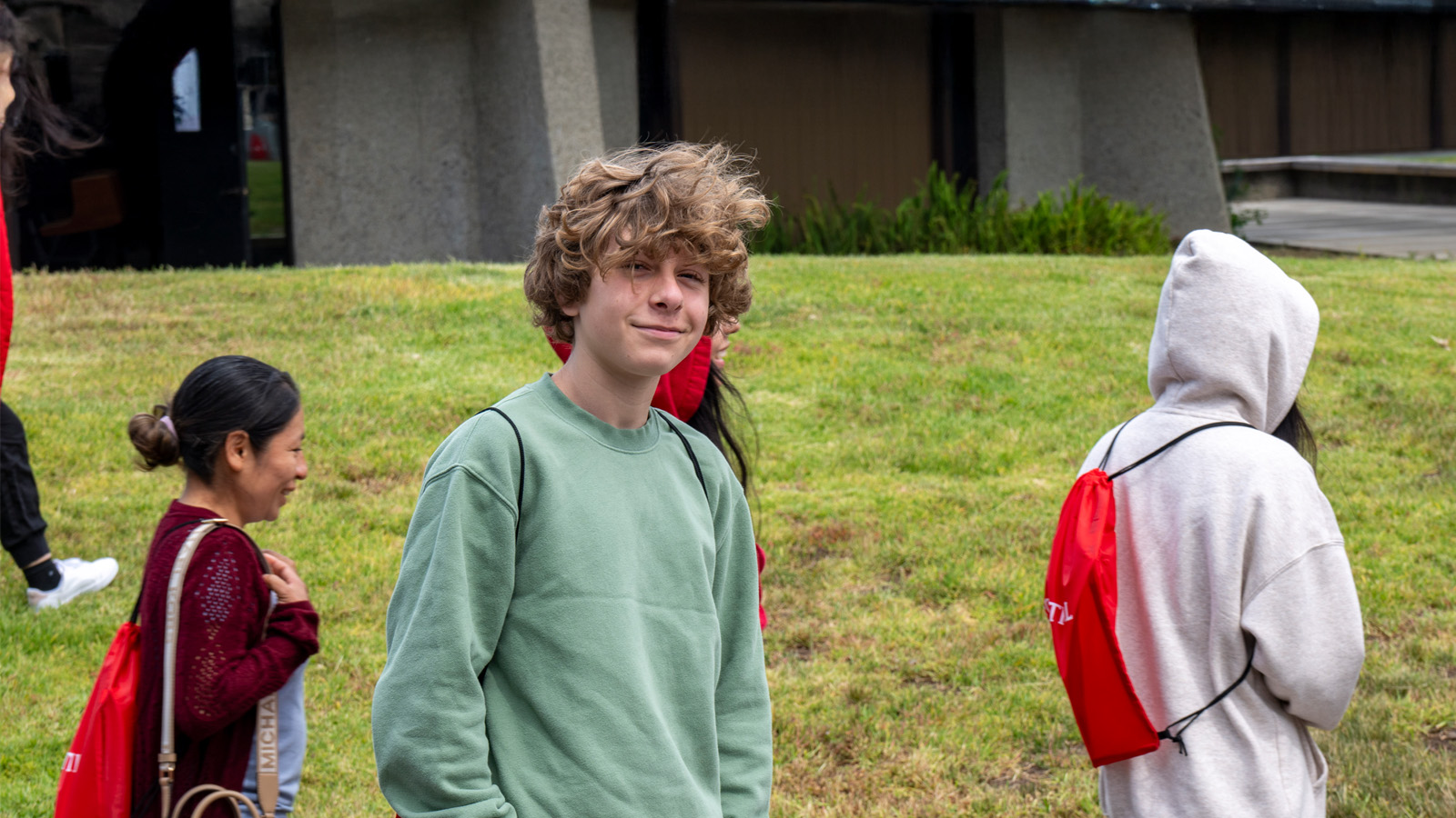 High school student participating in a guided tour of the campus