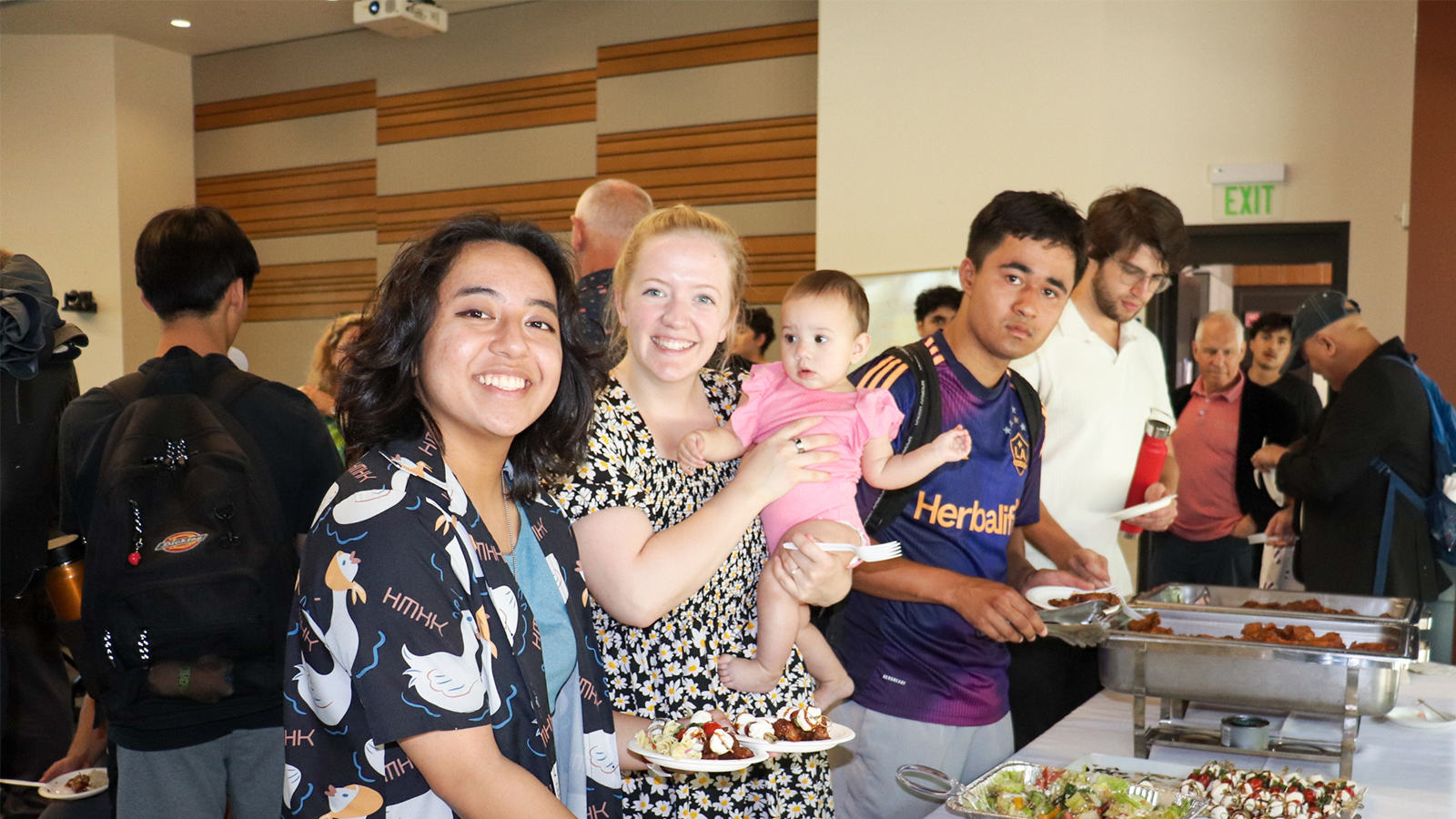 Female student with her baby at graduation end of the year celebration